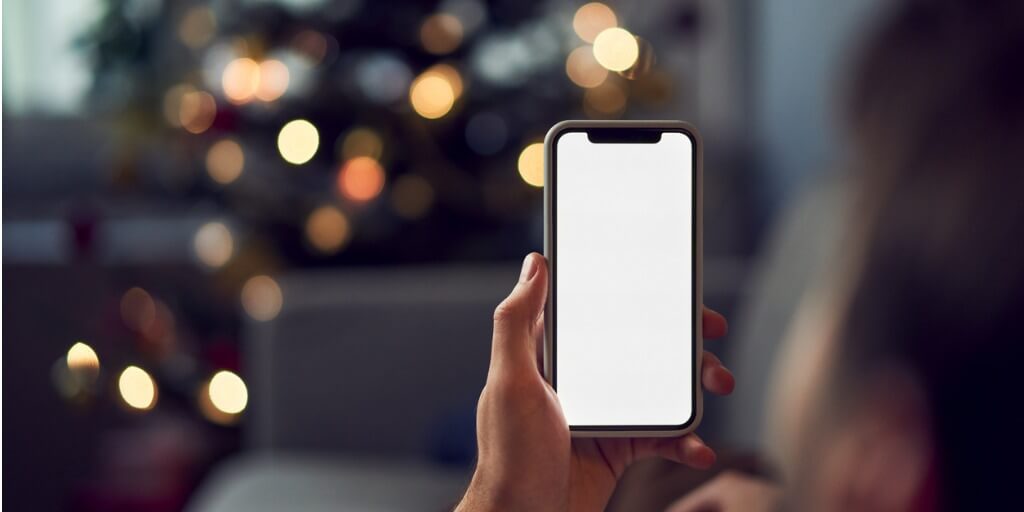 man-using-smartphone-during-christmas-at-home-picture-id1290221330 (1)